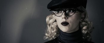 Movie still from “The Spirit” (2008), directed by Frank Miller – A person wearing glasses and a hat; Close Up shot, Low angle