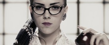 Movie still from “The Spirit” (2008), directed by Frank Miller – A person wearing glasses; Close Up shot, Low angle