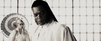 Movie still from “The Spirit” (2008), directed by Frank Miller – A man in a white shirt and a black and white background; Close Up shot, Low angle