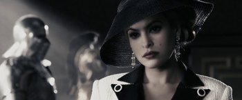 Movie still from “The Spirit” (2008), directed by Frank Miller – A woman wearing a black hat and a white jacket; Close Up shot, Low angle