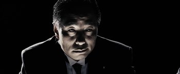 Movie still from “The Spirit” (2008), directed by Frank Miller – A person wearing a suit and tie; Close Up shot, Low angle