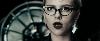 Movie still from “The Spirit” (2008), directed by Frank Miller – A person wearing glasses and a black shirt; Close Up shot, Low angle