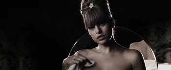 Movie still from “The Spirit” (2008), directed by Frank Miller – A beautiful woman with long brown hair holding a towel in her hand; Close Up shot, Low angle