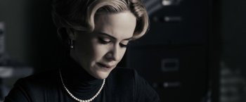 Movie still from “The Spirit” (2008), directed by Frank Miller – A person wearing a necklace; Close Up shot, Low angle