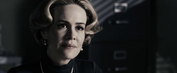 Movie still from “The Spirit” (2008), directed by Frank Miller – A person with short blonde hair; Close Up shot, Over the shoulder angle