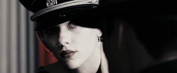 Movie still from “The Spirit” (2008), directed by Frank Miller – A person wearing a hat; Close Up shot, Low angle