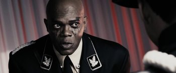 Movie still from “The Spirit” (2008), directed by Frank Miller – A person wearing a suit and tie; Close Up shot, Low angle