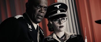 Movie still from “The Spirit” (2008), directed by Frank Miller – A man and a woman wearing military uniforms; Close Up shot, Low angle