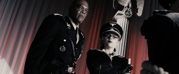 Movie still from “The Spirit” (2008), directed by Frank Miller – A man and a woman dressed in military uniforms; Medium shot, Low angle