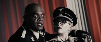 Movie still from “The Spirit” (2008), directed by Frank Miller – A man and a woman dressed in military uniforms; Close Up shot, Over the shoulder angle