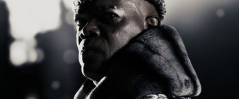 Movie still from “The Spirit” (2008), directed by Frank Miller – A person wearing a coat; Close Up shot, Low angle