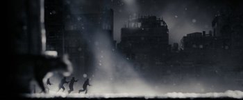 Movie still from “The Spirit” (2008), directed by Frank Miller – Two people running in the rain in front of a building; Extreme Wide shot, Low angle