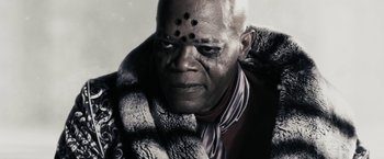 Movie still from “The Spirit” (2008), directed by Frank Miller – An older man with a black dot on his face; Close Up shot, Low angle