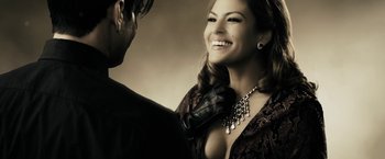 Movie still from “The Spirit” (2008), directed by Frank Miller – A man and a woman smiling for the camera; Close Up shot, Over the shoulder angle