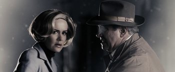 Movie still from “The Spirit” (2008), directed by Frank Miller – A man and a woman are looking at each other; Close Up shot, Over the shoulder angle