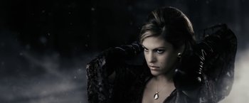 Movie still from “The Spirit” (2008), directed by Frank Miller – A woman in a black dress and a black glove; Close Up shot, Low angle