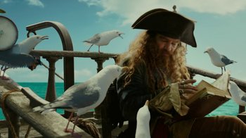 Movie still from “The SpongeBob Movie: Sponge Out of Water” (2015), directed by Mike Mitchell – A man dressed as a pirate with a bird on his shoulder; Medium shot, Over the shoulder angle