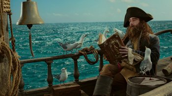 Movie still from “The SpongeBob Movie: Sponge Out of Water” (2015), directed by Mike Mitchell – A man sitting on a boat with seagulls; Medium shot, Low angle