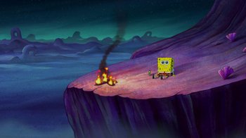 Movie still from “The SpongeBob Movie: Sponge Out of Water” (2015), directed by Mike Mitchell – A spongebob sitting on top of a cliff next to a fire; Extreme Wide shot, High angle