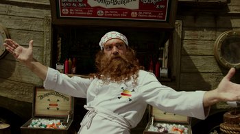 Movie still from “The SpongeBob Movie: Sponge Out of Water” (2015), directed by Mike Mitchell – A man with a red beard is dressed as a chef; Medium shot, Low angle