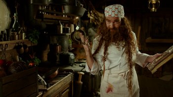 Movie still from “The SpongeBob Movie: Sponge Out of Water” (2015), directed by Mike Mitchell – A man with long red hair and a beard is holding a frying pan; Medium shot, Low angle