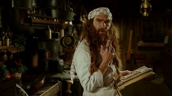 Movie still from “The SpongeBob Movie: Sponge Out of Water” (2015), directed by Mike Mitchell – A man with long hair and a long beard is standing in a kitchen; Medium shot, Low angle