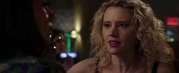 Movie still from “The Spy Who Dumped Me” (2018), directed by Susanna Fogel – A person with curly blonde hair; Close Up shot, Over the shoulder angle