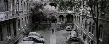 Movie still from “The Spy Who Dumped Me” (2018), directed by Susanna Fogel – Smoke billows out of a building on fire; Extreme Wide shot, High angle