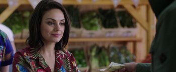 Movie still from “The Spy Who Dumped Me” (2018), directed by Susanna Fogel – A woman is smiling while looking at a dollar bill; Close Up shot, Over the shoulder angle