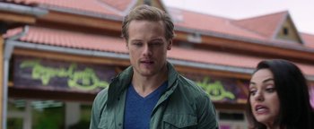 Movie still from “The Spy Who Dumped Me” (2018), directed by Susanna Fogel – A person wearing a green jacket; Close Up shot, Over the shoulder angle