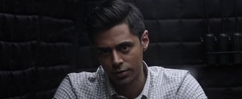 Movie still from “The Spy Who Dumped Me” (2018), directed by Susanna Fogel – A person wearing a checkered shirt; Close Up shot, Over the shoulder angle