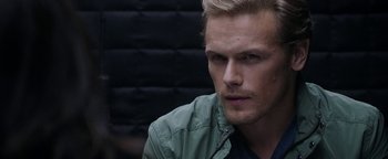 Movie still from “The Spy Who Dumped Me” (2018), directed by Susanna Fogel – A person wearing a green jacket; Close Up shot, Over the shoulder angle