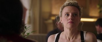 Movie still from “The Spy Who Dumped Me” (2018), directed by Susanna Fogel – A person sitting in a room; Close Up shot, Over the shoulder angle