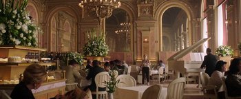 Movie still from “The Spy Who Dumped Me” (2018), directed by Susanna Fogel – People are sitting at tables in an ornate restaurant; Wide shot, High angle