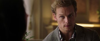 Movie still from “The Spy Who Dumped Me” (2018), directed by Susanna Fogel – A person wearing a shirt and jacket; Close Up shot, Over the shoulder angle