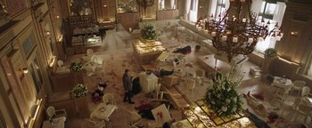 Movie still from “The Spy Who Dumped Me” (2018), directed by Susanna Fogel – A room filled with tables and chairs covered in blood; Wide shot, High angle