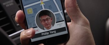 Movie still from “The Spy Who Dumped Me” (2018), directed by Susanna Fogel – A person holding a smart phone in their hand; Extreme Close Up shot, High angle