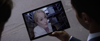 Movie still from “The Spy Who Dumped Me” (2018), directed by Susanna Fogel – A person holding up a tablet with a picture on it; Close Up shot, Overhead angle