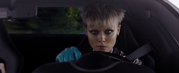 Movie still from “The Spy Who Dumped Me” (2018), directed by Susanna Fogel – A woman in a car looking at the camera; Close Up shot, Over the shoulder angle