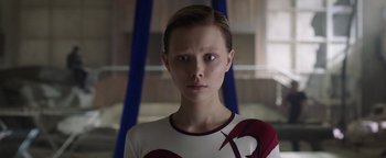 Movie still from “The Spy Who Dumped Me” (2018), directed by Susanna Fogel – A young woman in a red and white shirt; Close Up shot, Low angle