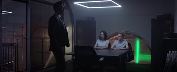 Movie still from “The Spy Who Dumped Me” (2018), directed by Susanna Fogel – Two women sitting at a table in front of a man; Wide shot, Over the shoulder angle