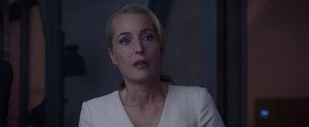 Movie still from “The Spy Who Dumped Me” (2018), directed by Susanna Fogel – A woman in a white dress is looking at the camera; Close Up shot, Over the shoulder angle