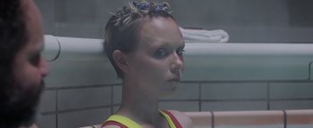 Movie still from “The Spy Who Dumped Me” (2018), directed by Susanna Fogel – A woman in a yellow and red tank top; Close Up shot, Over the shoulder angle
