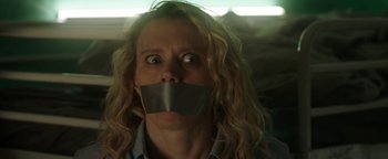 Movie still from “The Spy Who Dumped Me” (2018), directed by Susanna Fogel – A woman with duct tape over her mouth; Close Up shot, Low angle