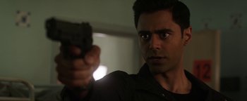 Movie still from “The Spy Who Dumped Me” (2018), directed by Susanna Fogel – A person holding a gun; Close Up shot, Over the shoulder angle