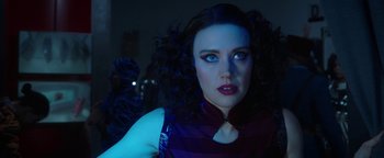 Movie still from “The Spy Who Dumped Me” (2018), directed by Susanna Fogel – A person with long black curly hair; Close Up shot, Over the shoulder angle