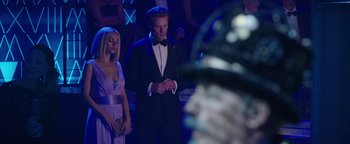 Movie still from “The Spy Who Dumped Me” (2018), directed by Susanna Fogel – A man and a woman standing in front of an audience; Medium shot, Over the shoulder angle