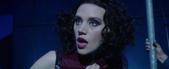 Movie still from “The Spy Who Dumped Me” (2018), directed by Susanna Fogel – A person with curly black hair; Close Up shot, High angle