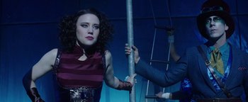 Movie still from “The Spy Who Dumped Me” (2018), directed by Susanna Fogel – A woman standing next to a man holding a pole; Medium shot, Low angle