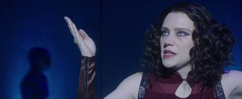 Movie still from “The Spy Who Dumped Me” (2018), directed by Susanna Fogel – A woman holding her hand up in the air; Close Up shot, Low angle